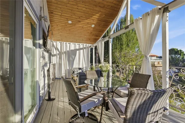 a view of balcony with chairs and outdoor seating