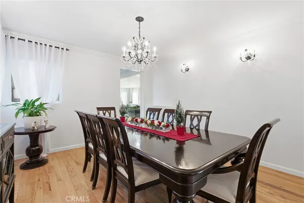 a view of a dining room with furniture and chandelier