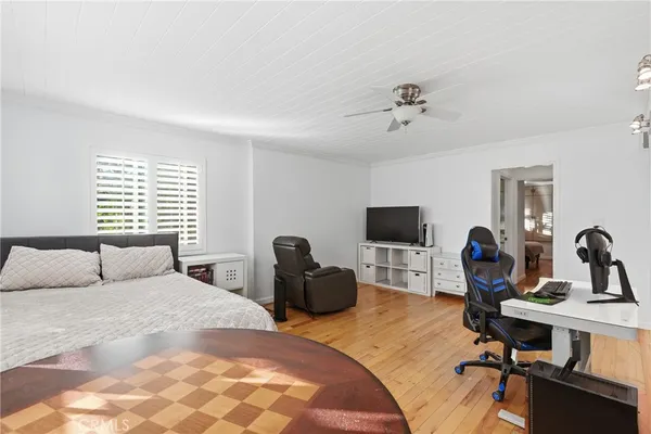 a bedroom with a bed window and a desk