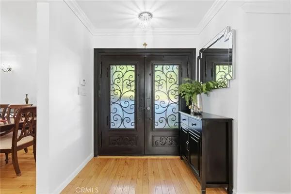 a view of entryway with a front door and wooden floor