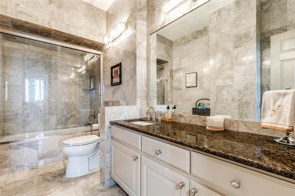5200 Keller Springs Road, Unit 535 Dallas, TX 75248 - Photo 11 of 25 a bathroom with a granite countertop sink a toilet a mirror and shower