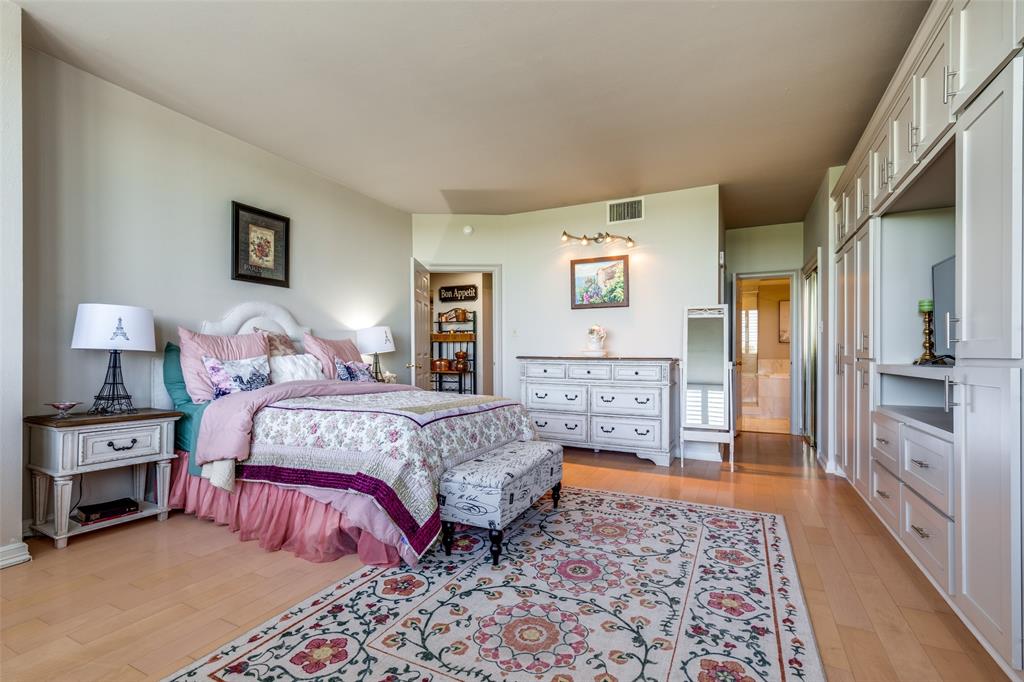 5200 Keller Springs Road, Unit 535 Dallas, TX 75248 - Photo 12 of 25 a bedroom with a bed and a chandelier