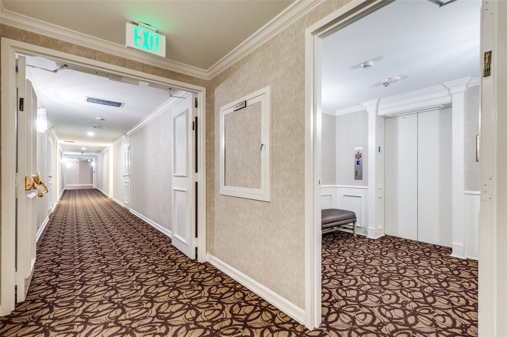5200 Keller Springs Road, Unit 535 Dallas, TX 75248 - Photo 18 of 25 a view of a hallway with bedroom and wooden floor