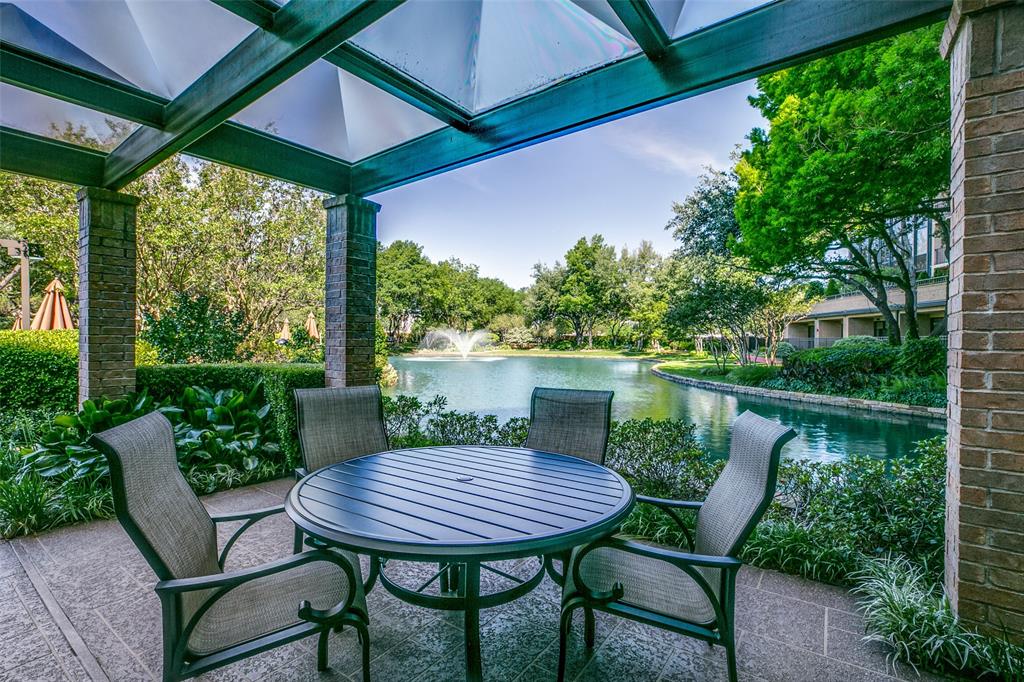 5200 Keller Springs Road, Unit 535 Dallas, TX 75248 - Photo 24 of 25 a view of a patio with table and chairs under an umbrella