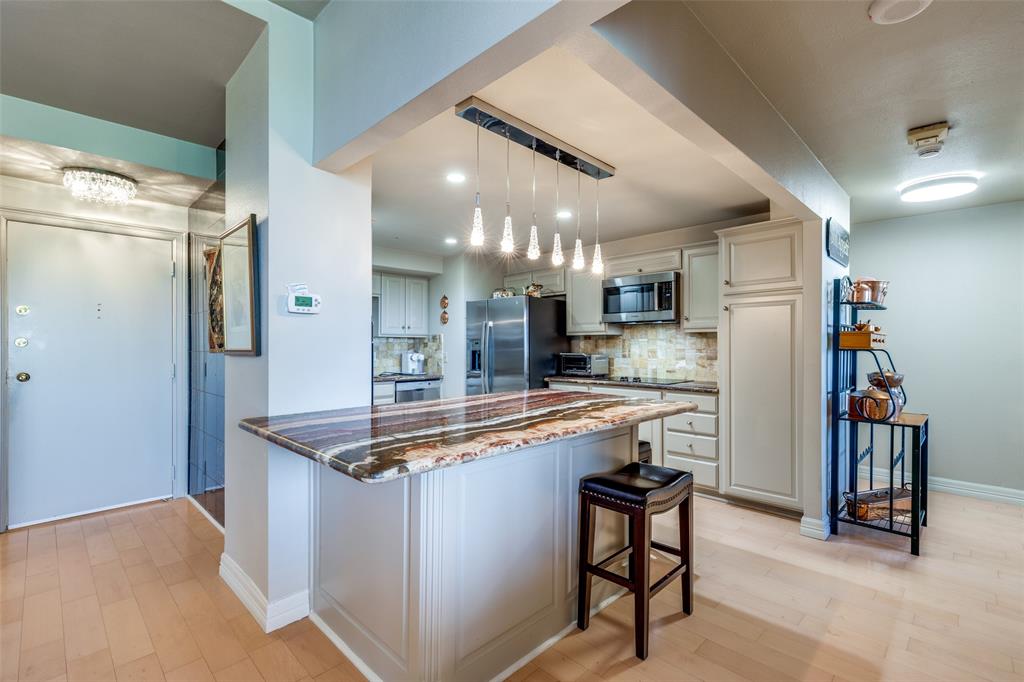 5200 Keller Springs Road, Unit 535 Dallas, TX 75248 - Photo 3 of 25 a kitchen with stainless steel appliances granite countertop a sink and a refrigerator