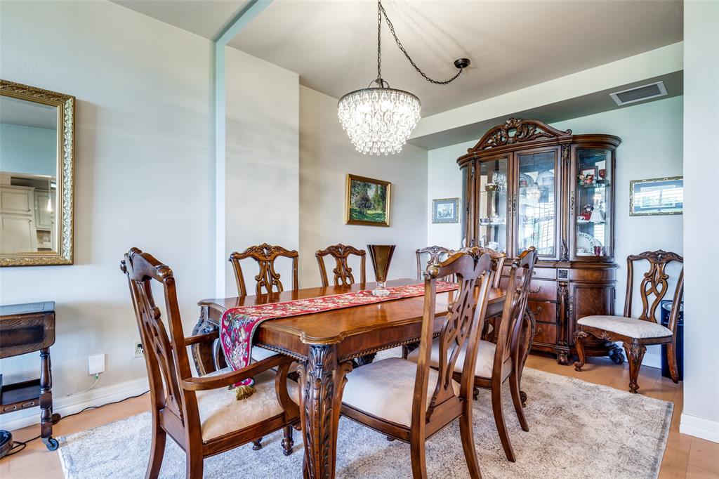 5200 Keller Springs Road, Unit 535 Dallas, TX 75248 - Photo 5 of 25 a view of a dining room with furniture and a chandelier