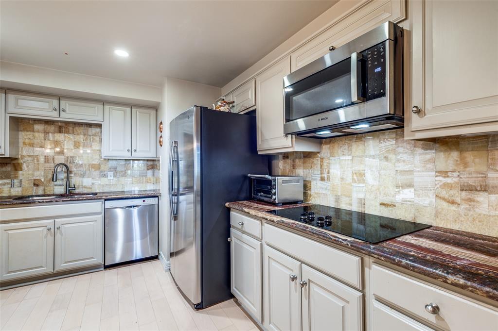 5200 Keller Springs Road, Unit 535 Dallas, TX 75248 - Photo 7 of 25 a kitchen with stainless steel appliances granite countertop a sink a stove a microwave and cabinets