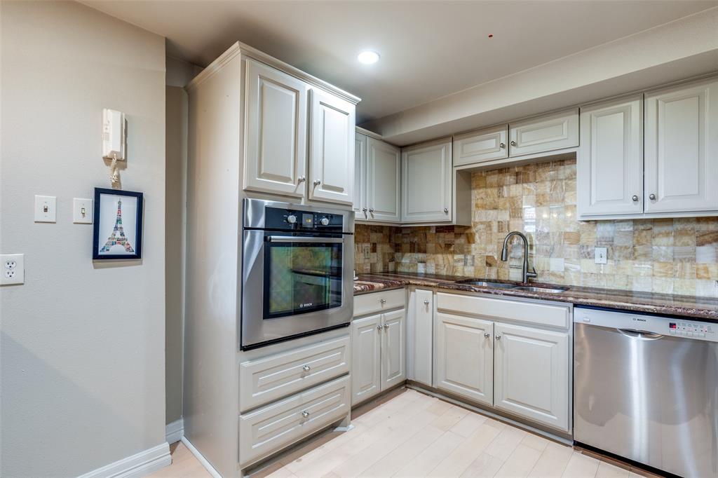5200 Keller Springs Road, Unit 535 Dallas, TX 75248 - Photo 9 of 25 a kitchen with stainless steel appliances granite countertop white cabinets and sink