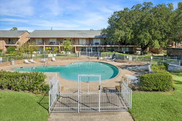 a view of a house with swimming pool and sitting area