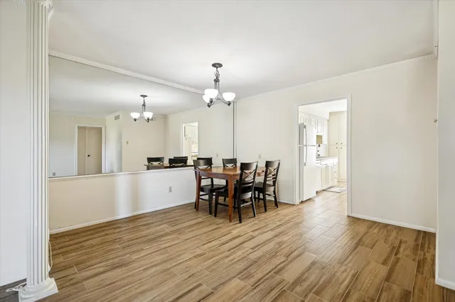 a view of a dining room with furniture and chandelier