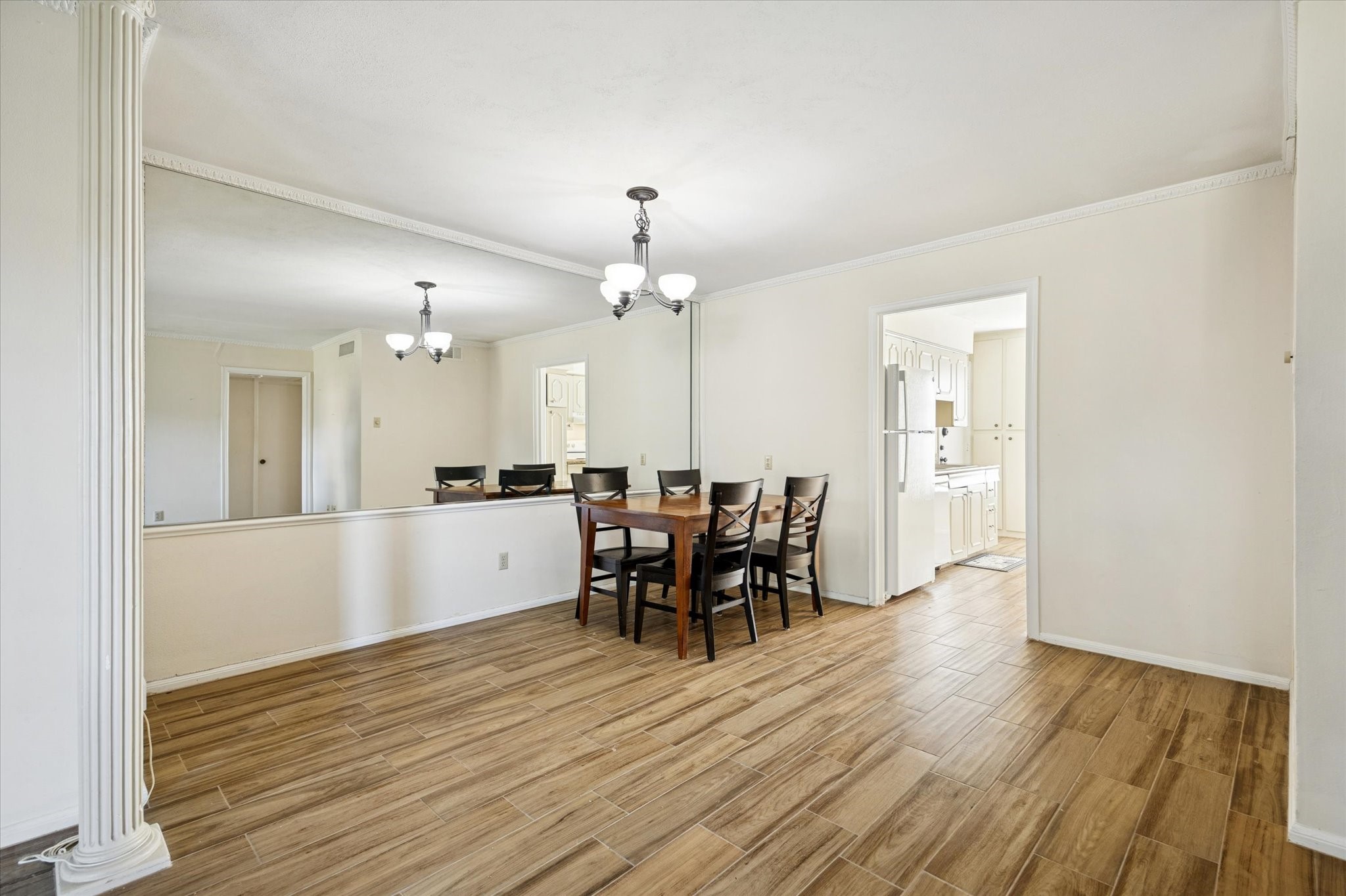 7600 Burgoyne Road, Unit 152 Houston, TX 77063 - Photo 3 of 16 a view of a dining room with furniture and chandelier