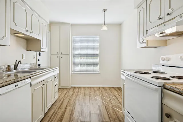 a kitchen with a sink stove and cabinets