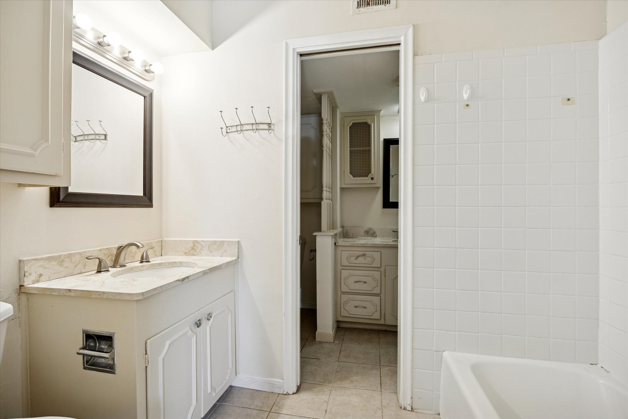 7600 Burgoyne Road, Unit 152 Houston, TX 77063 - Photo 8 of 16 a bathroom with a sink and a mirror