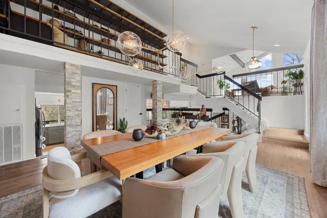 a view of a dining room with furniture a chandelier and wooden floor