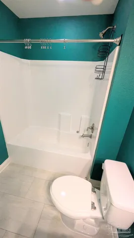 a bathroom with a toilet and a bathtub