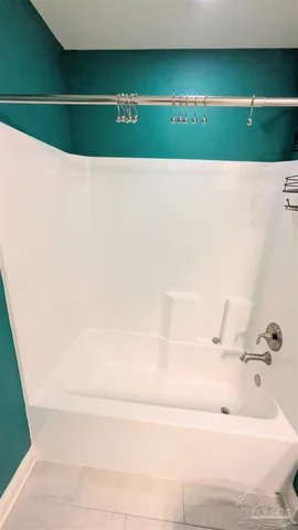 a bathroom with a bathtub and shower