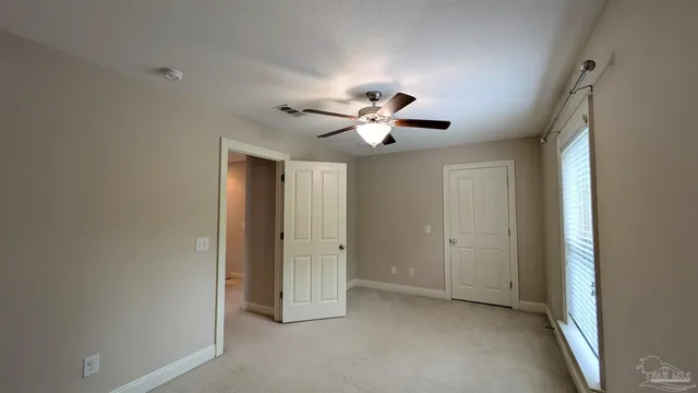 a view of an empty room with a ceiling fan