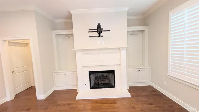 an empty room with a fireplace and a window