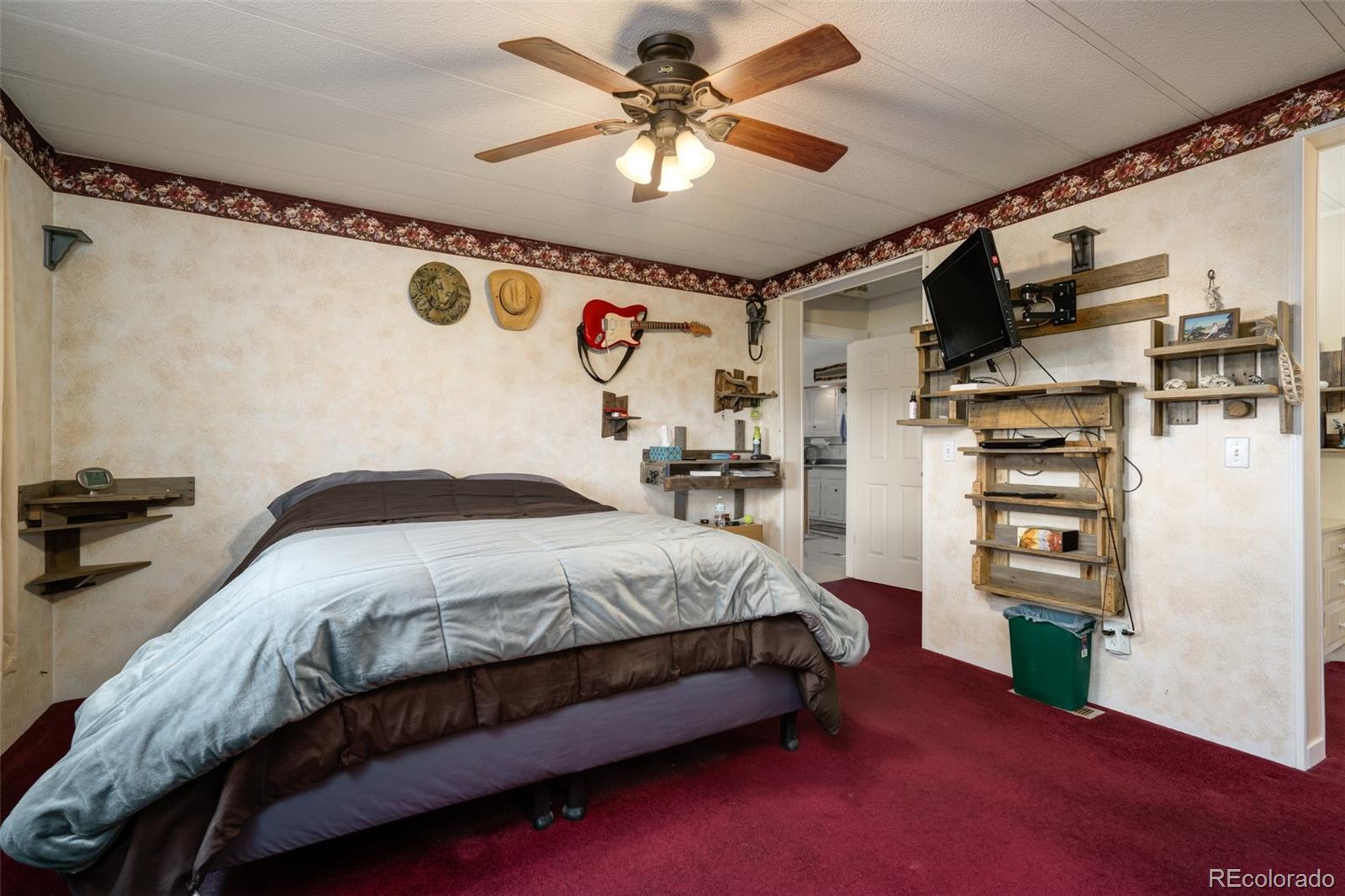 97862 E Highway Hayden, CO 81639 - Photo 13 of 30 a bedroom with a bed and a chandelier