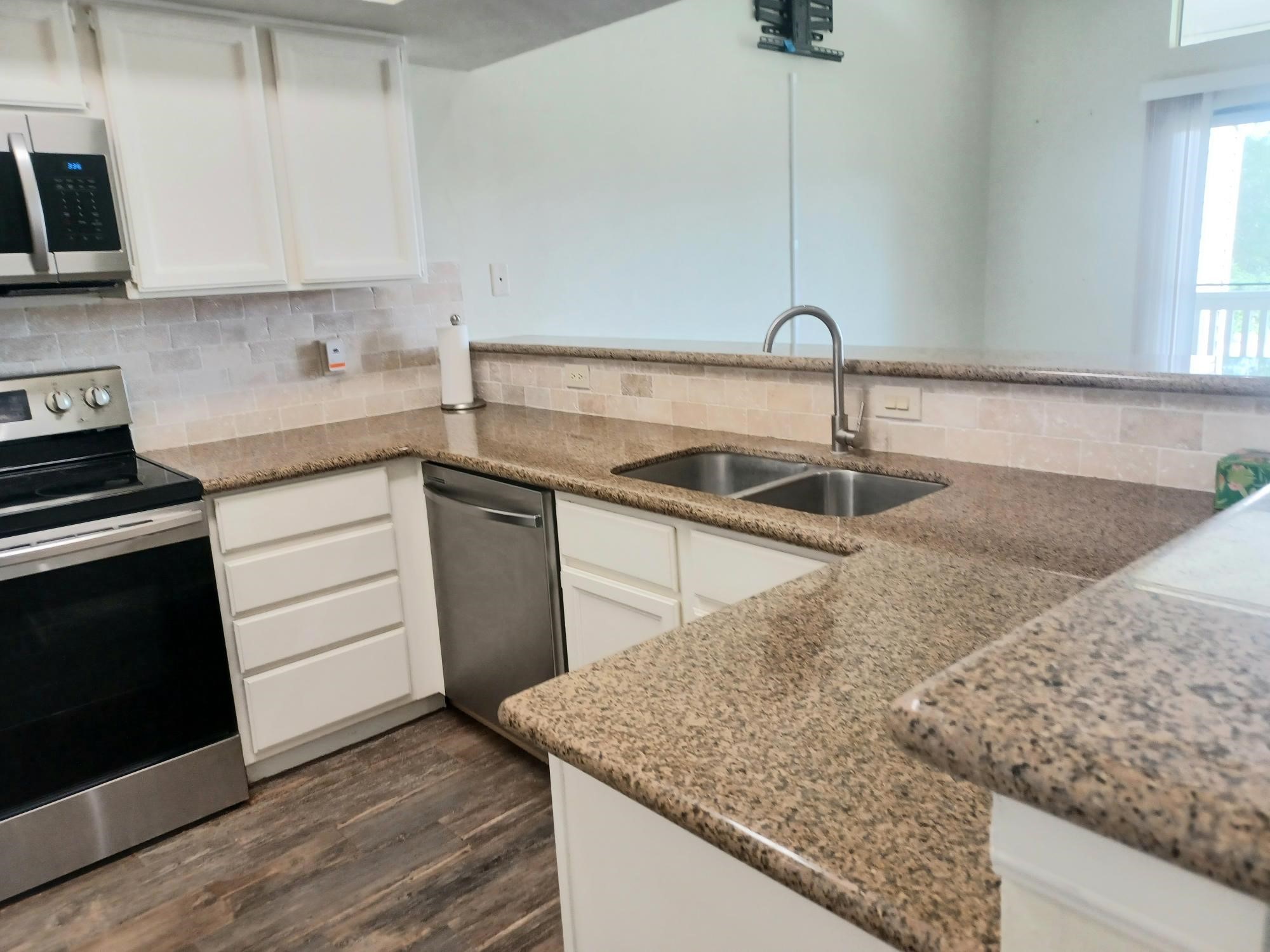 128 April Point Drive South Conroe, TX 77356 - Photo 8 of 26 a kitchen with a sink stove and cabinets