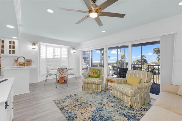 a living room with furniture and a floor to ceiling window