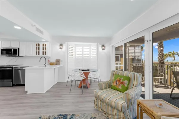 a kitchen with a sink a refrigerator a stove and cabinets