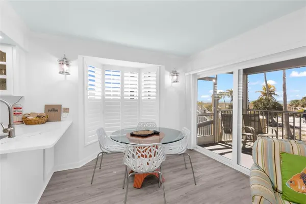 a kitchen with stainless steel appliances granite countertop white cabinets a microwave oven and a sink