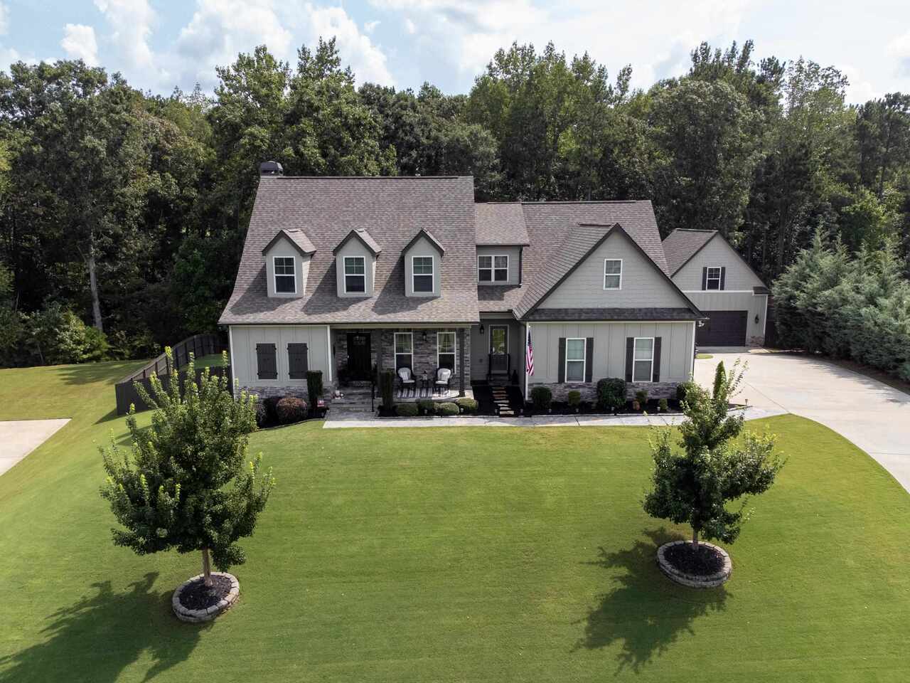 36 Daniel Drive Newnan, GA 30265 - Photo 1 of 1 a front view of a house with garden and porch