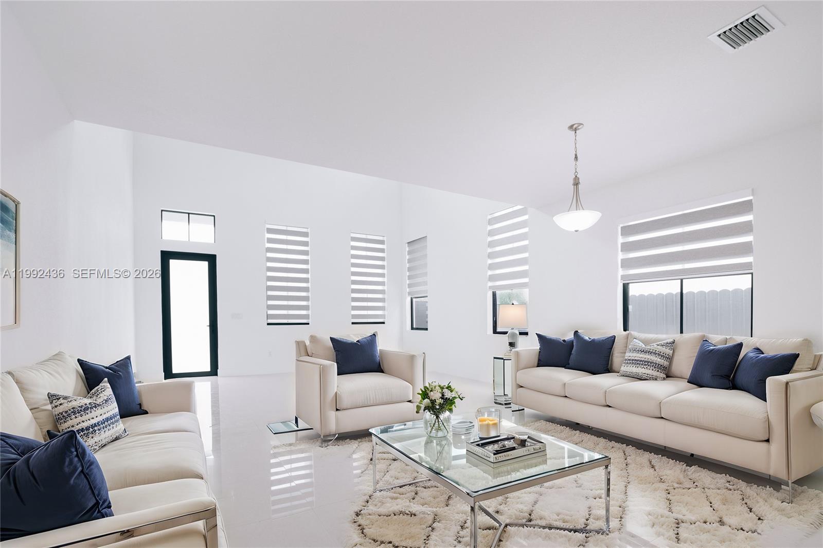 1841 Southwest 145th Avenue, Unit 1841 Miami, FL 33175 - Photo 2 of 23 a living room with furniture kitchen view and a large window