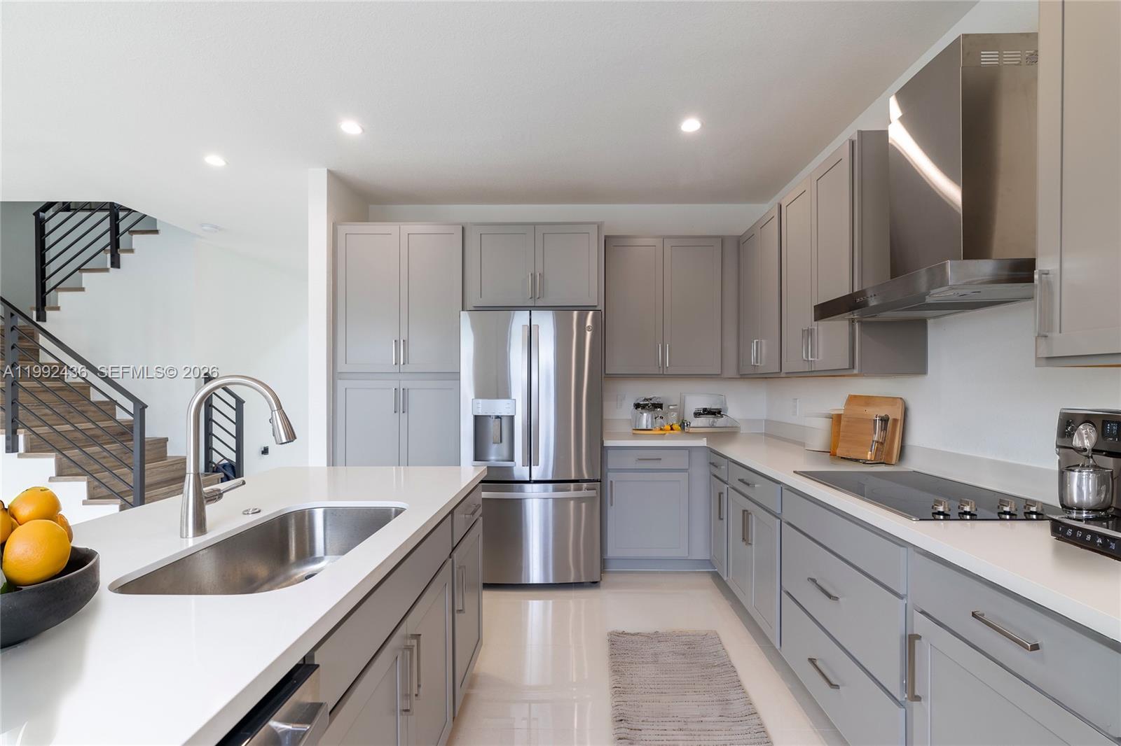 1841 Southwest 145th Avenue, Unit 1841 Miami, FL 33175 - Photo 5 of 23 a kitchen with stainless steel appliances a sink a stove and cabinets