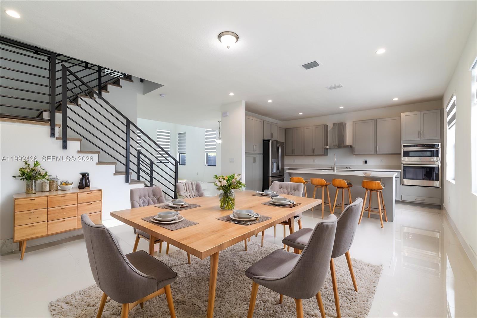 1841 Southwest 145th Avenue, Unit 1841 Miami, FL 33175 - Photo 7 of 23 a view of a dining room and livingroom with furniture wooden floor and a rug