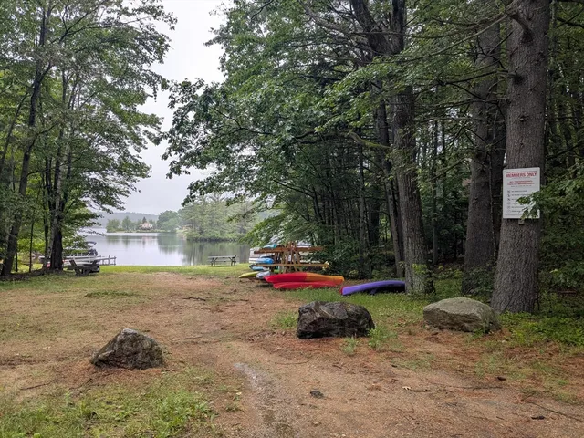 a view of backyard with table and chairs and a fire pit