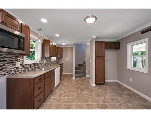 41 Florida Street Springfield, MA 01109 - Photo 11 of 23 a kitchen with stainless steel appliances granite countertop a stove a sink and a microwave