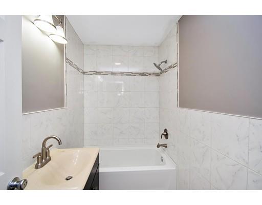 41 Florida Street Springfield, MA 01109 - Photo 15 of 23 a bathroom with a tub sink a mirror and shower