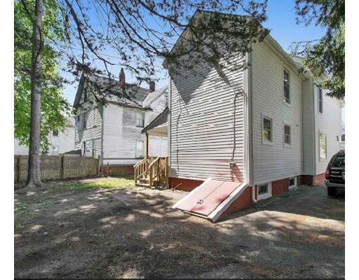 41 Florida Street Springfield, MA 01109 - Photo 2 of 23 a view of a backyard with a large tree