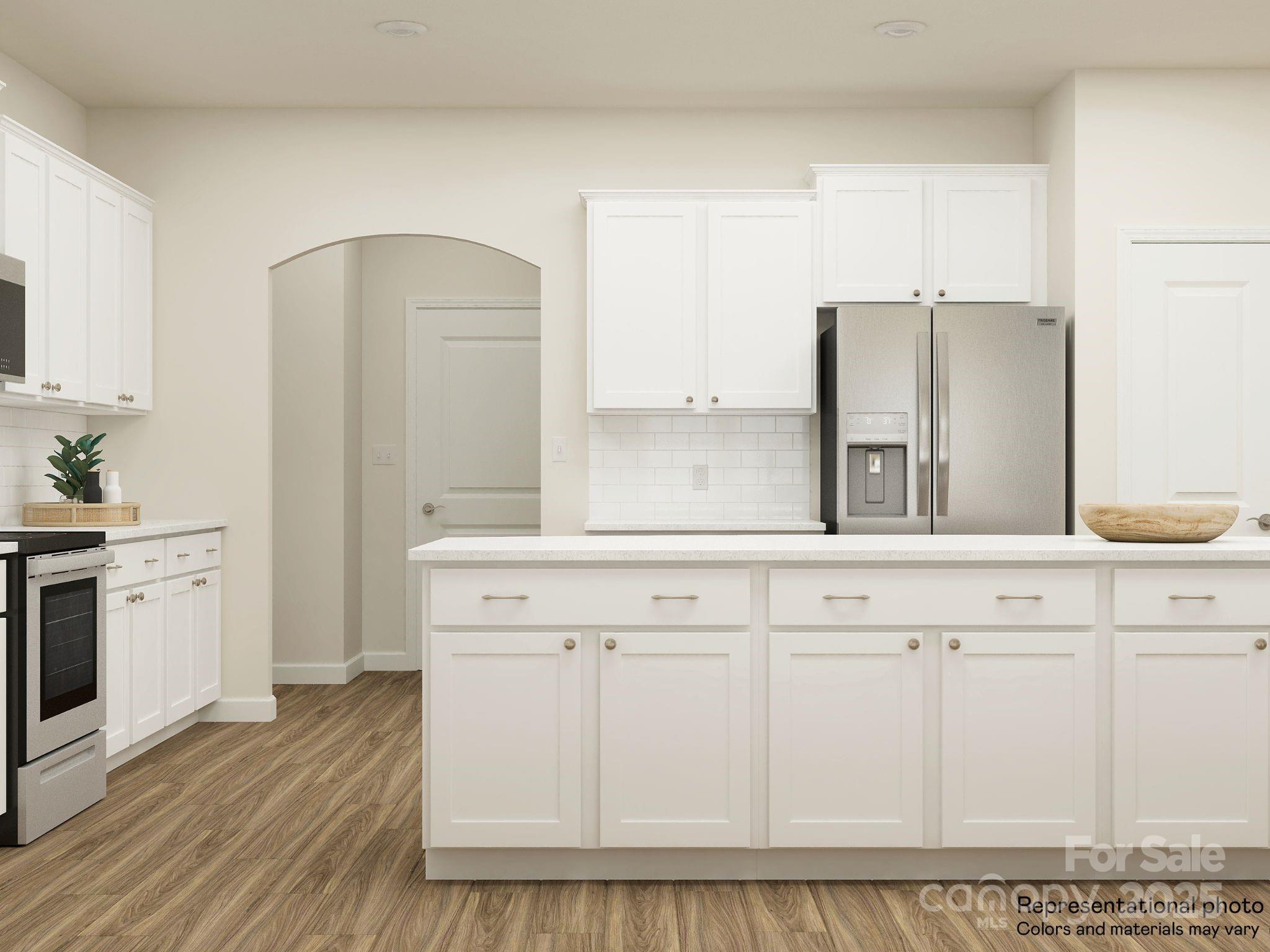 4122 Camden Gln Road Lancaster, SC 29720 - Photo 11 of 26 a kitchen with granite countertop white cabinets and white appliances