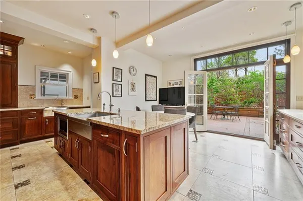 a large kitchen with a stove and large window