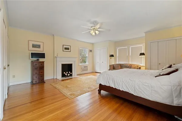 a spacious bedroom with a large bed and a fireplace