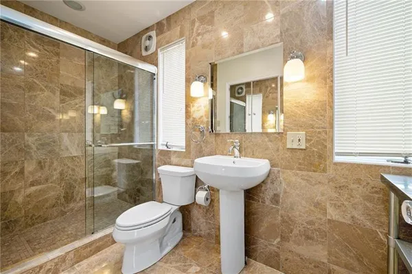a bathroom with a sink toilet and shower