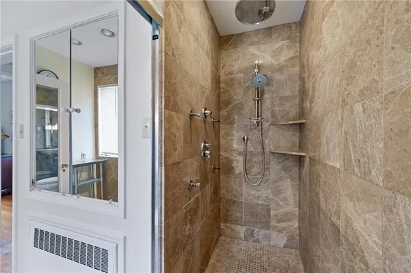 a bathroom with a shower and a sink