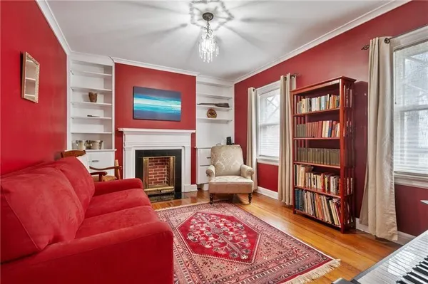 a living room with furniture fireplace and rug