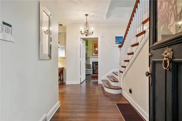 a view of an entryway with wooden floor and stairs
