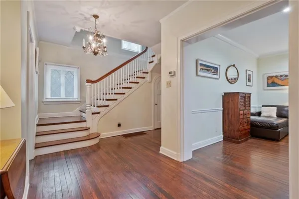 a view of entryway and hall with wooden floor