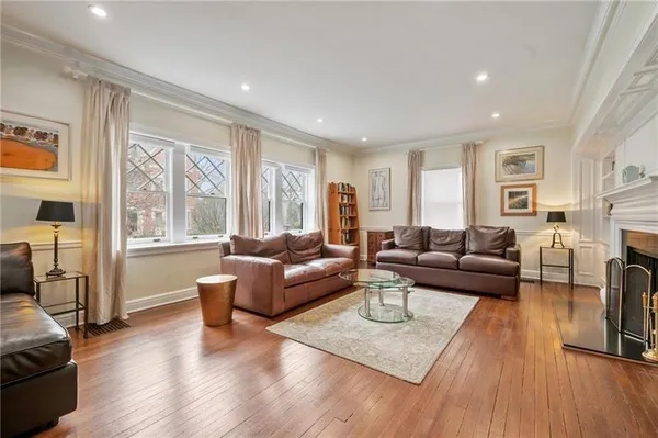 a living room with fireplace furniture and a wooden floor