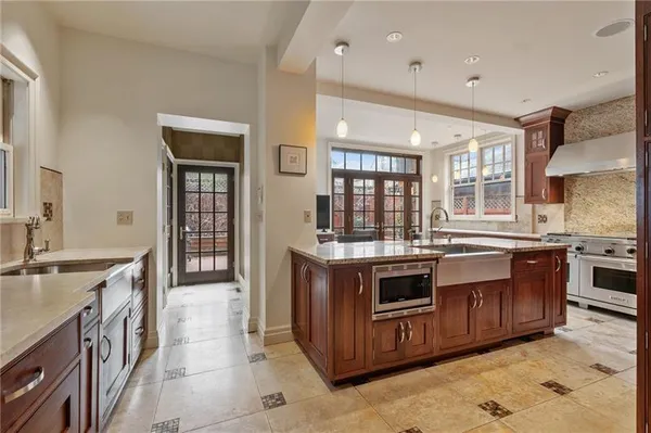 a kitchen with stainless steel appliances granite countertop a stove and a sink