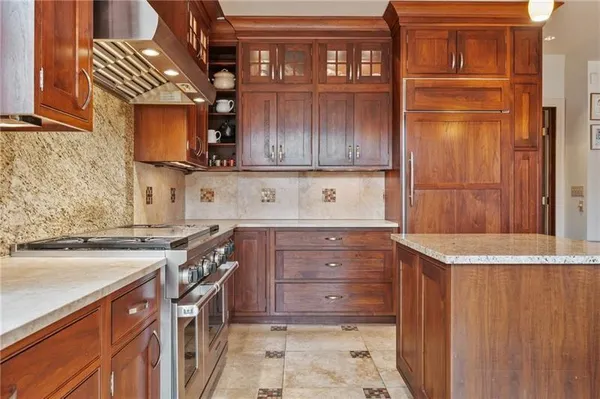 a kitchen with a stove and a refrigerator