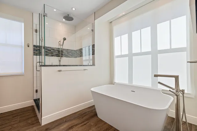 a bathroom with a bathtub and a shower