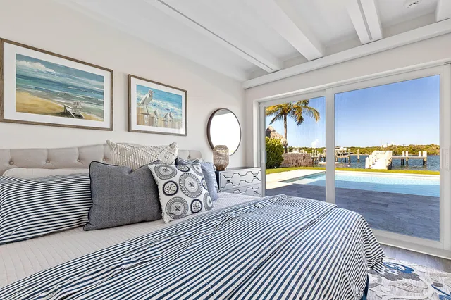 a bedroom with a large bed and a painting on the wall