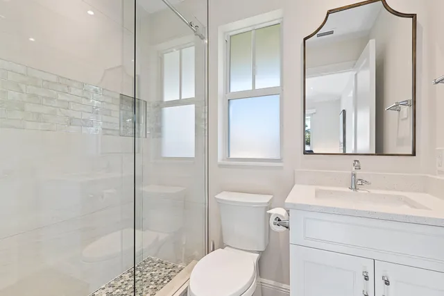 a bathroom with a sink toilet and shower