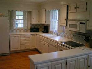1529 Andover Road Charlotte, NC 28211 - Photo 2 of 8 a kitchen with stainless steel appliances granite countertop a sink a stove and a microwave